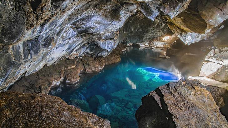 An emerald lagoon within a rock cave