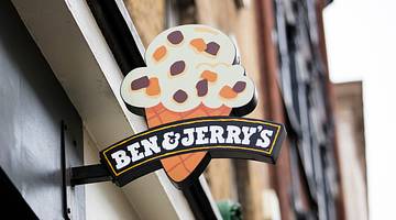 A building with an ice cream cone sign that says "Ben & Jerry's"