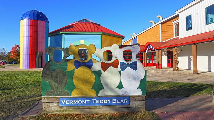A board with teddy bear shapes that says "Vermont Teddy Bear" and colorful buildings