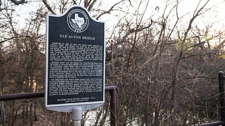 An informational plaque that says "Old Alton Bridge" with other text below it
