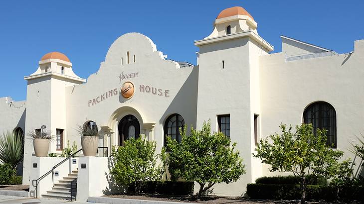 A white structure with towers and an orange "Anaheim Packing House" sign
