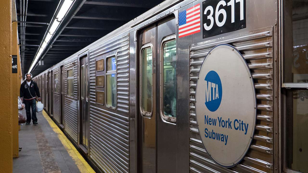 A subway car on the platform with New York City Subway sign