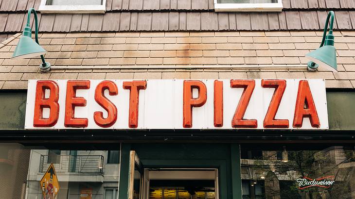 An NYC pizzeria with a red Best Pizza sign above the door