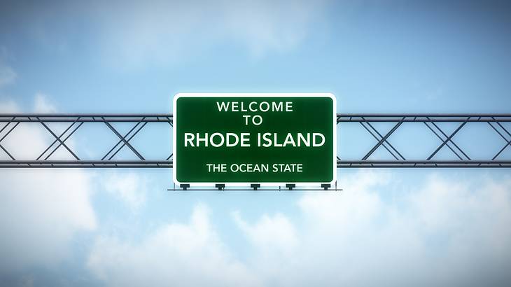 Green road sign that reads "Welcome to Rhode Island, The Ocean State" Green road sign that reads "Welcome to Rhode Island, The Ocean State"