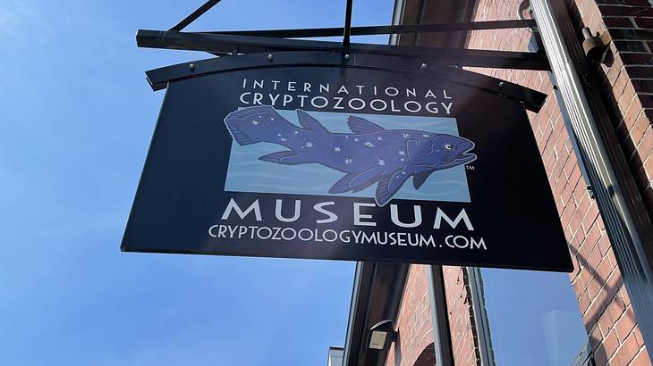 A blue sign on a building that says "International Cryptozoology Museum"