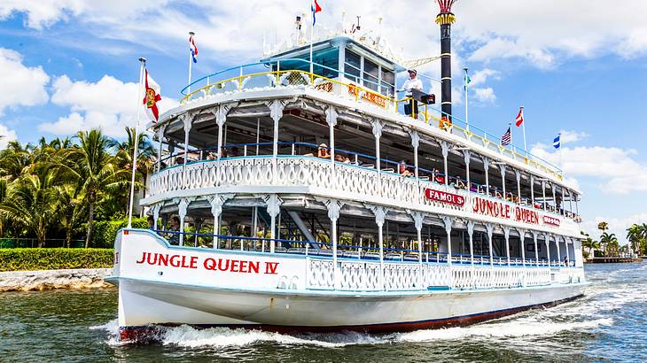 An old-fashioned riverboat on the water that says "Jungle Queen IV"