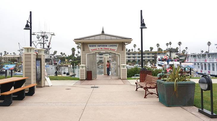 A walkway by the water next to an arch that says "Marine Emporium Landing"