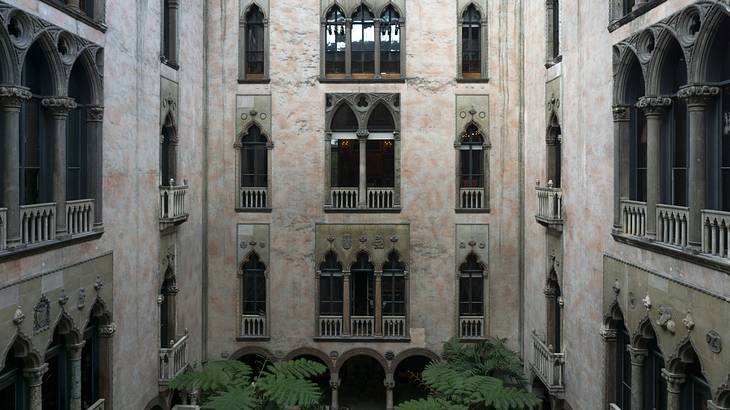 A multi-story courtyard with rows of ornate windows on each level