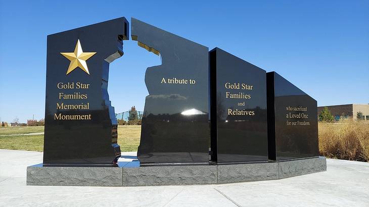 A black granite memorial structure that says Gold Star Families Memorial Monument
