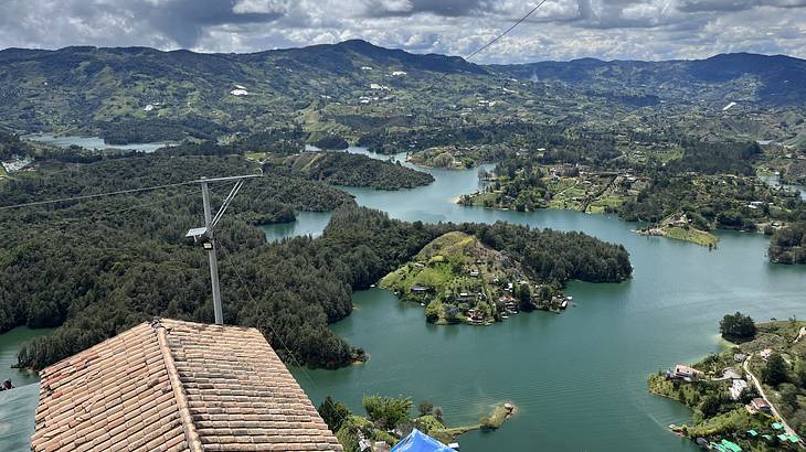 View of a flooded valley with many green islets from above on a partly cloudy day