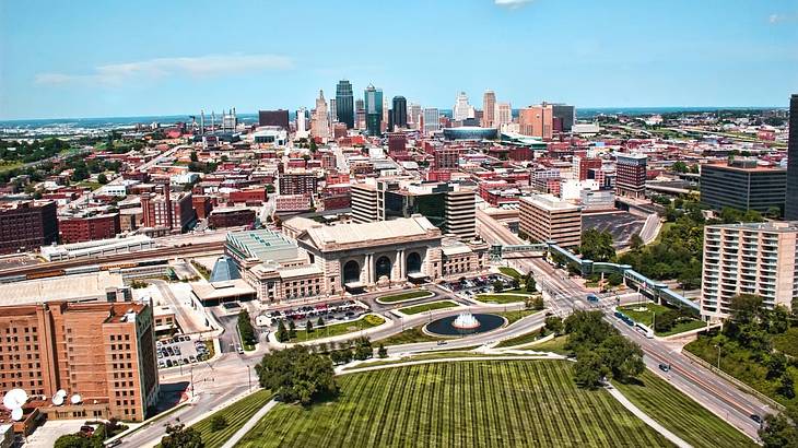 An aerial view of Kansas City with a stone building with columns and skyscrapers