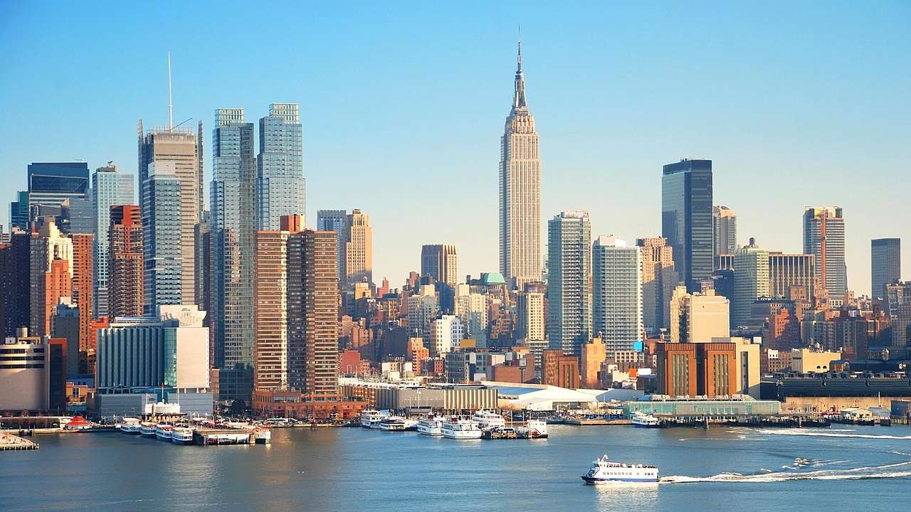 The Manhattan skyline with skyscrapers and the Empire State Building next to water