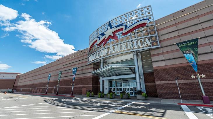 The exterior of a mall with a large "Mall of America" sign with a red and blue star