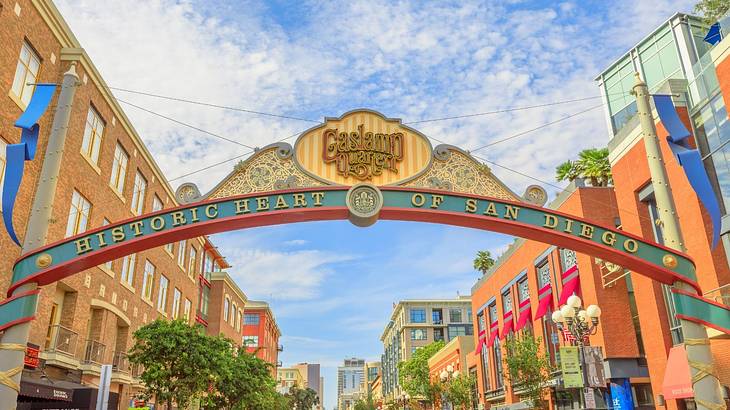 A sign over a street that says "Gaslamp Quarter, Historic Heart of San Diego"