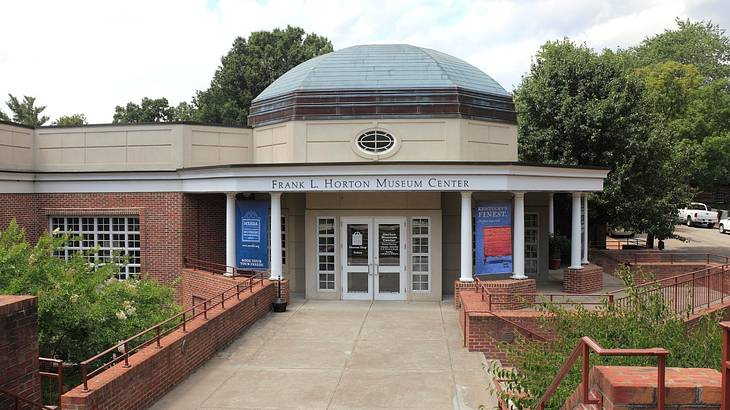 A small building with a domed roof and a Frank L. Horton Museum Center sign on it