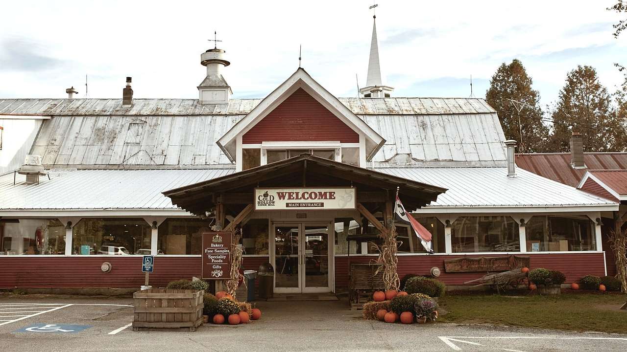 A red barn-style building with a welcome sign on the front