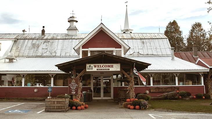 A red barn-style building with a welcome sign on the front