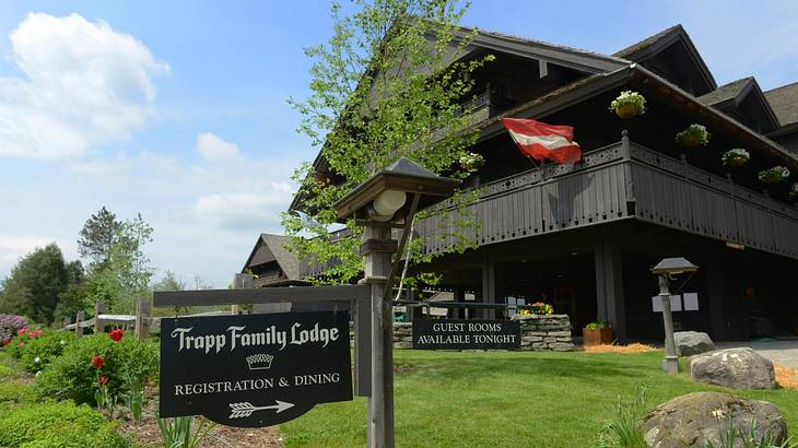 An Austrian-style wooden lodge with a sign that says "Trapp Family Lodge"
