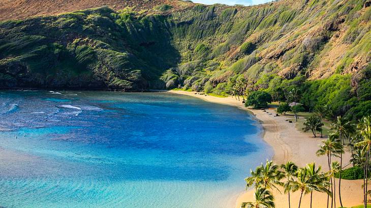 An ocean bay created by a volcanic crater filled with blue ocean water