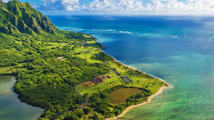 An aerial view of an island with yellow sandy beaches on the coastline and blue ocean