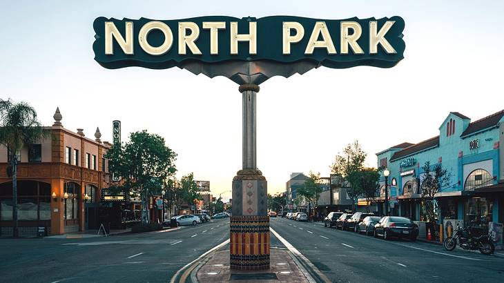 A sign that says "North Park" in the middle of a street at night