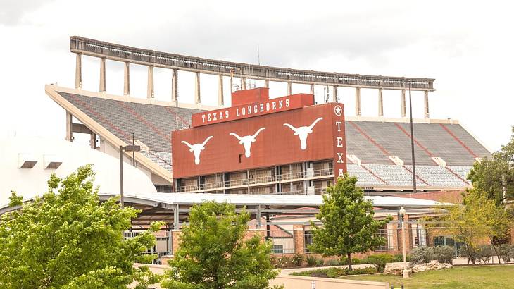 A sports stadium and a sign that says "Texas Longhorns" A sports stadium and a sign that says "Texas Longhorns"