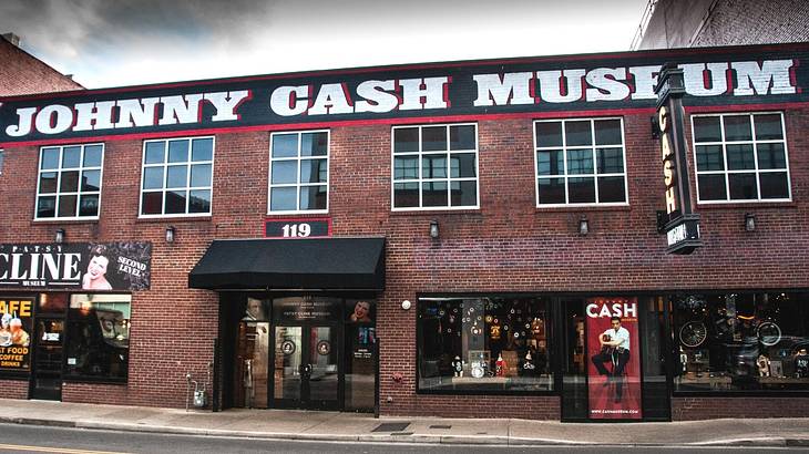 A red brick building with a black and white "Johnny Cash Museum" sign on it