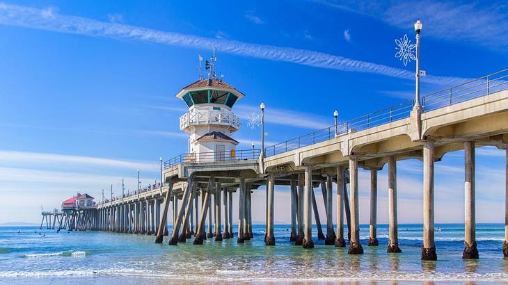 A pier stretching out into the ocean under a blue sky A pier stretching out into the ocean under a blue sky