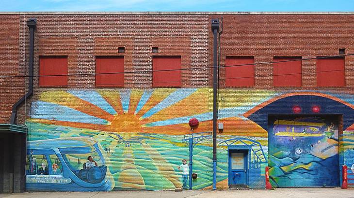 A brick building with a colorful mural painted on it