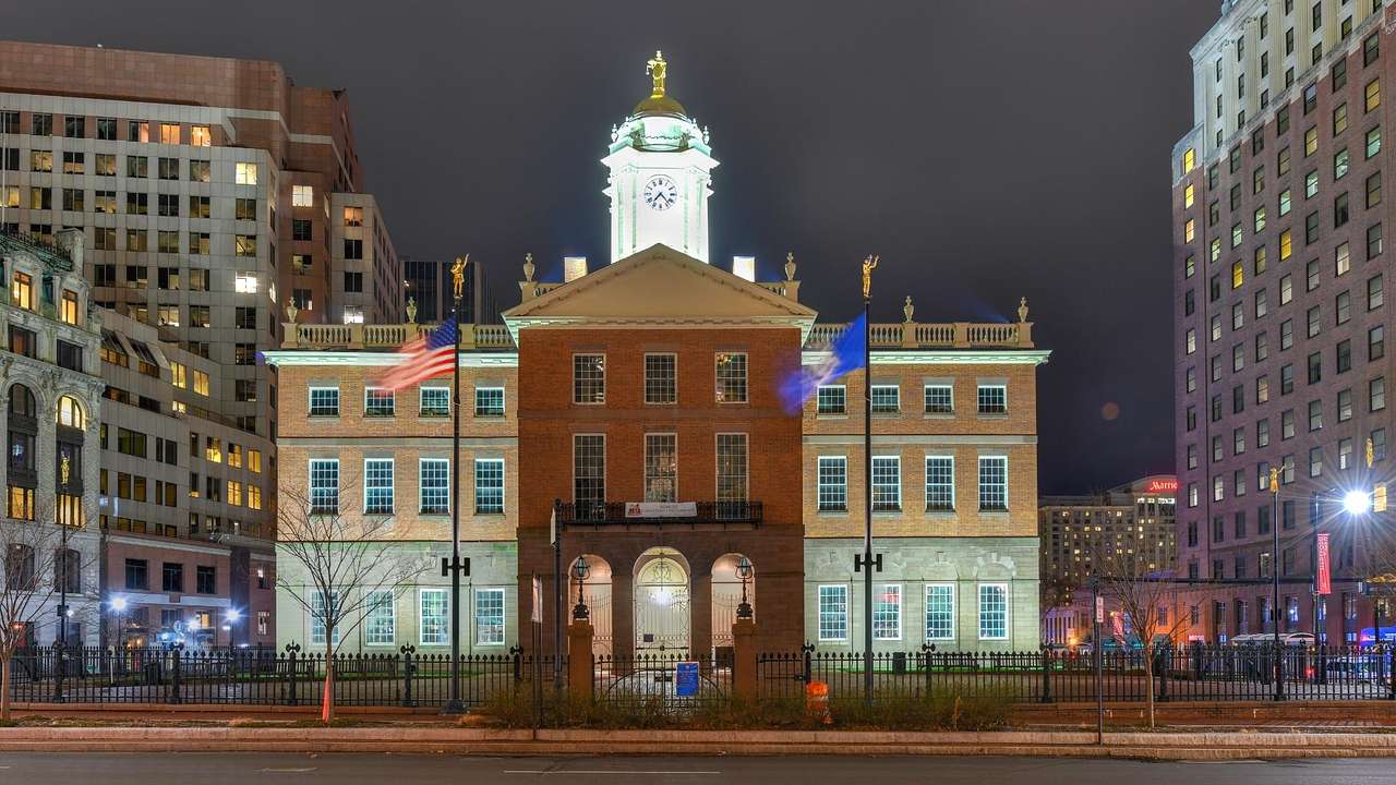 A statehouse with domed-roof illuminated at night