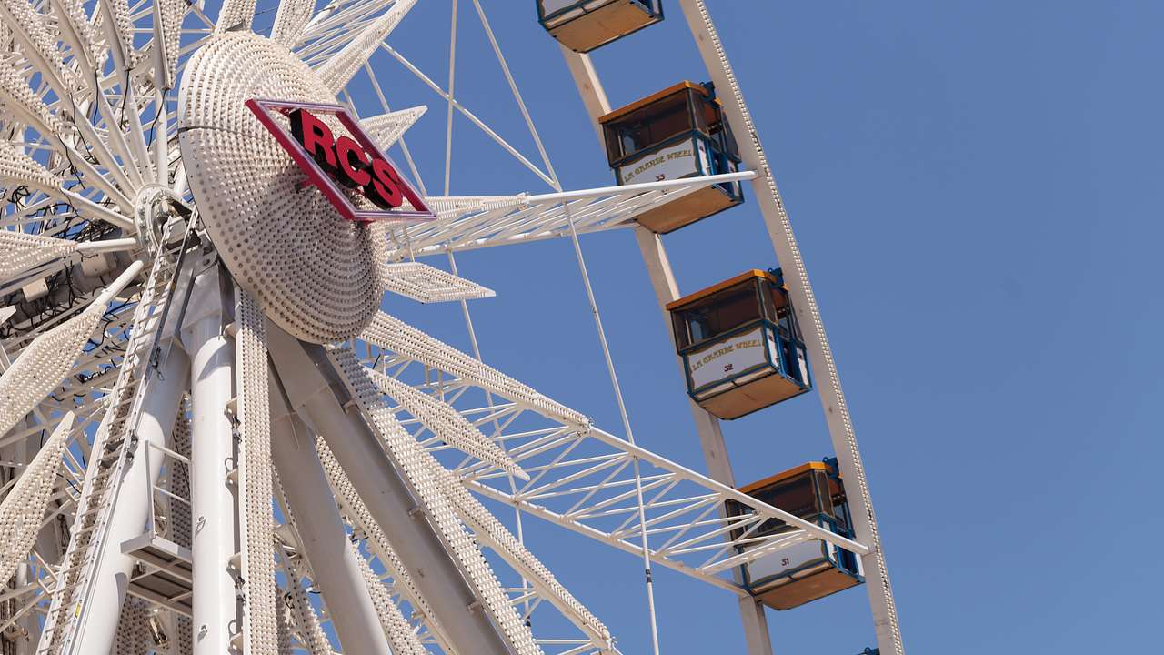 A Ferris wheel with a blue sky behind it