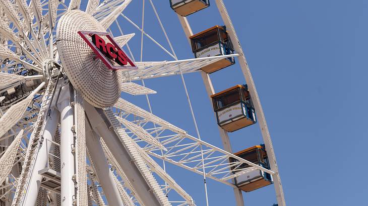 A Ferris wheel with a blue sky behind it