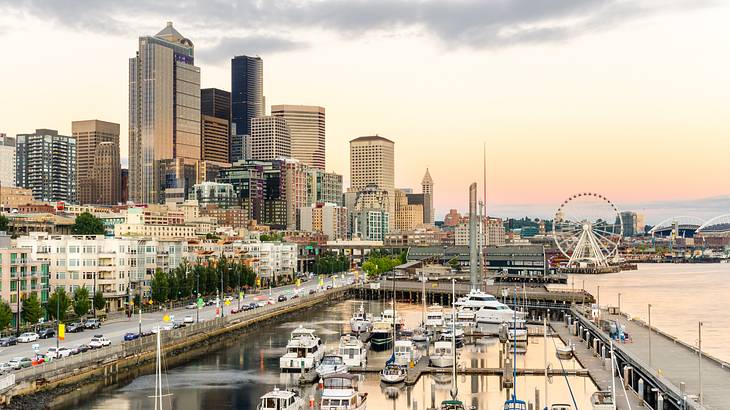 A waterfront with boats in the marina and buildings to the side