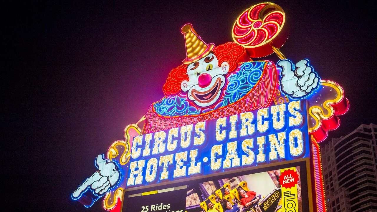 A neon sign with a clown and a sign that says "Circus Circus Hotel Casino"