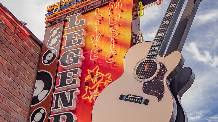 Building sign "Legends Corner" with neon lights and music notes along with a guitar