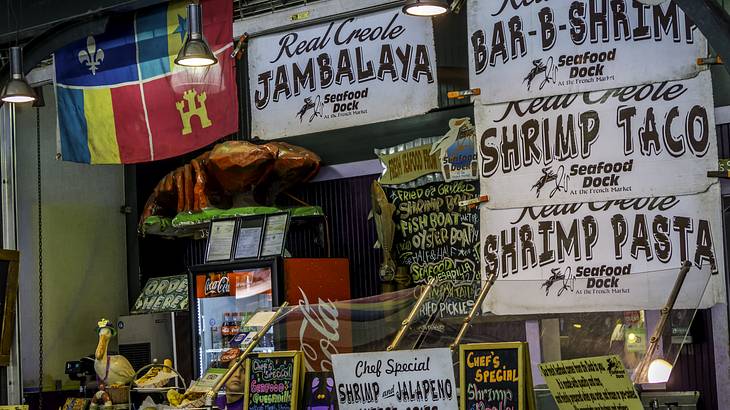 A market stall with menu signs, a flag, and products