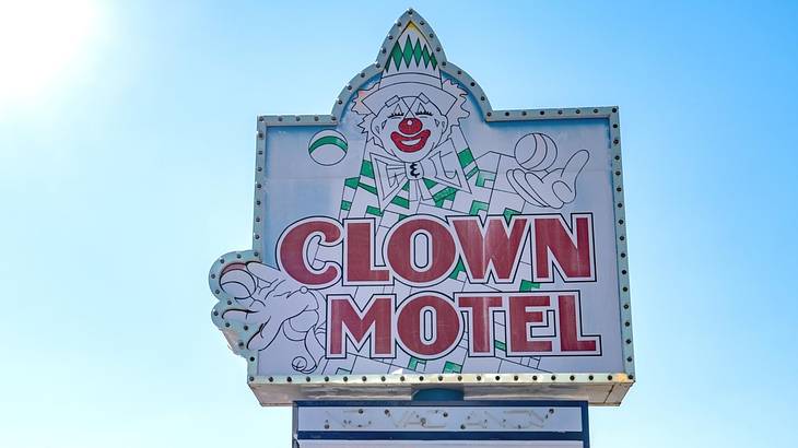 A sign that says "Clown Motel" with a clown drawing on it