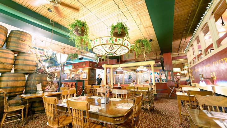 The interior of an Italian restaurant with wooden tables and chairs The interior of an Italian restaurant with wooden tables and chairs