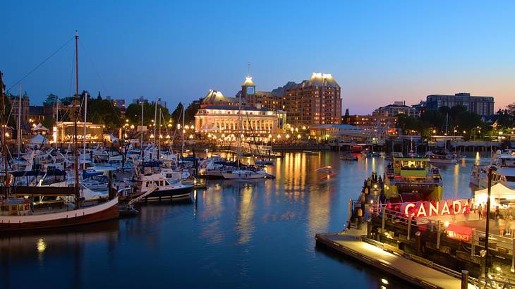 View of a harbour, boats and parliament building, Victoria, BC, Canada