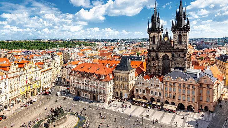An old square surrounded by buildings, a cathedral and people from above An old square surrounded by buildings, a cathedral and people from above