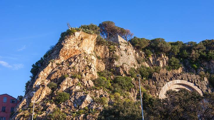 View of a sandstone cliff with green trees on it, Castle Hill, Nice, France View of a sandstone cliff with green trees on it, Castle Hill, Nice, France