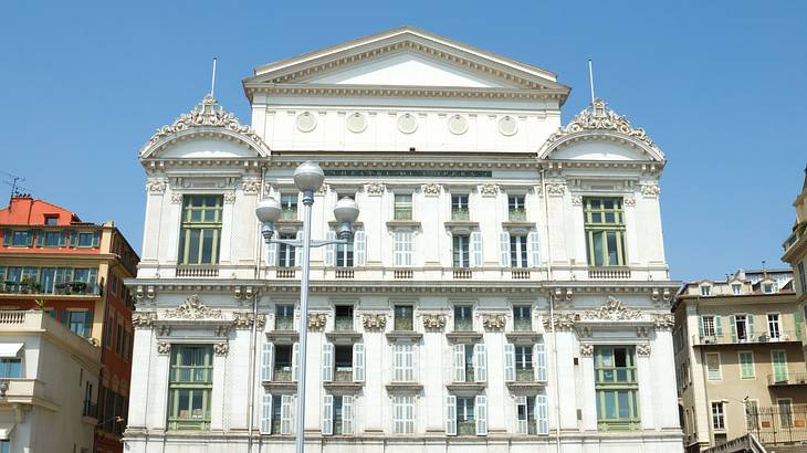 The outside of a white opera building in Nice, France The outside of a white opera building in Nice, France