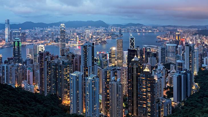 View of city buildings and lights from a peak at sunset, Hong Kong