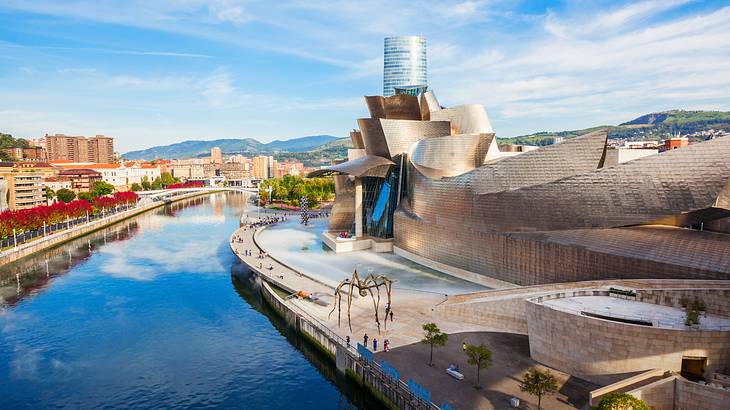 The impressive architecture of the Guggenheim Museum along a canal, Bilbao, Spain