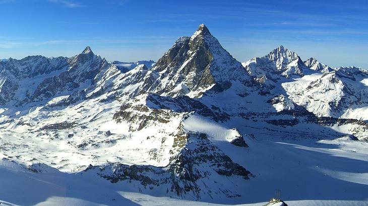 Panorama of snow-capped peaks on a clear blue day Panorama of snow-capped peaks on a clear blue day