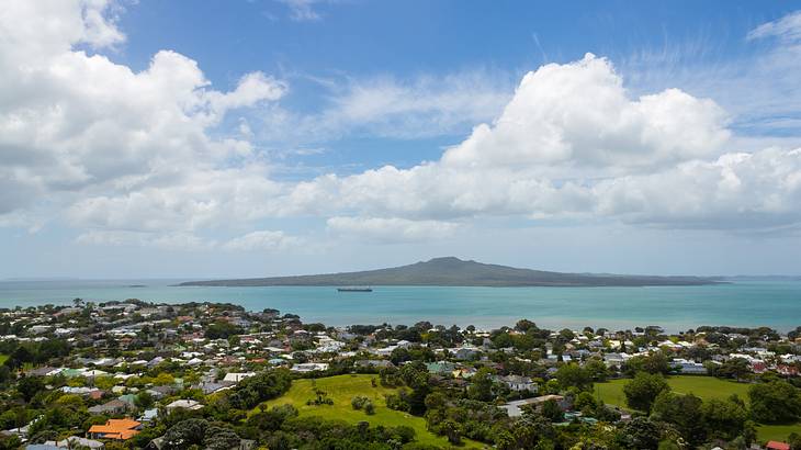 View of a volcano, homes, greenery and water, Rangitoto Island, NZ