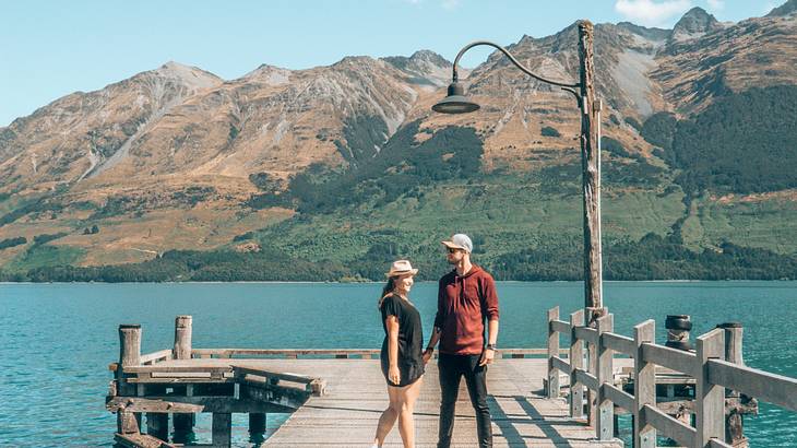 Man and woman holding hands on the Glenorchy Jetty, NZ