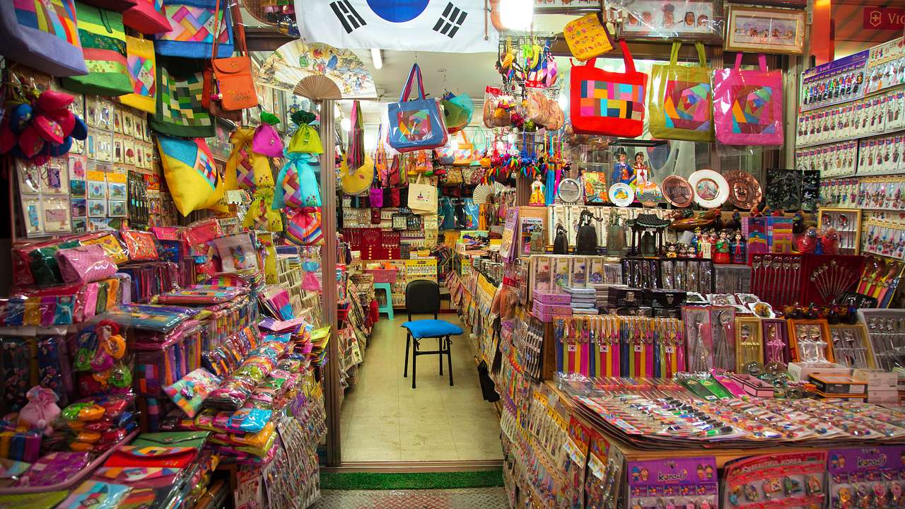 A colourful market with products and a South Korean flag on display