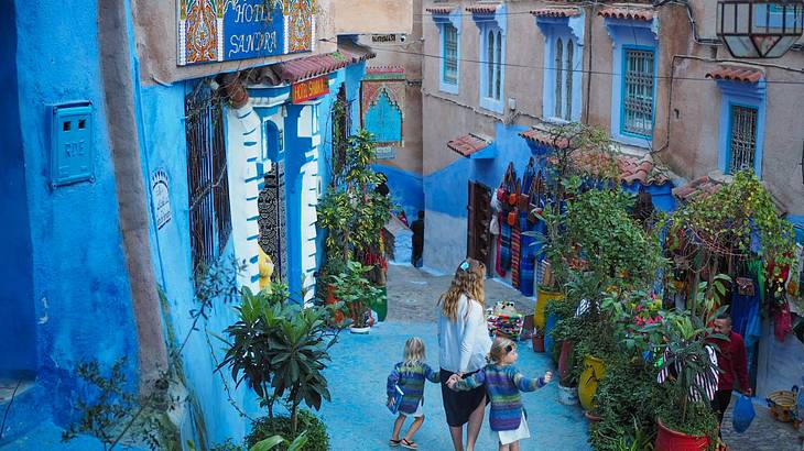 Family exploring the Blue City of Chefchaoun, Morocco