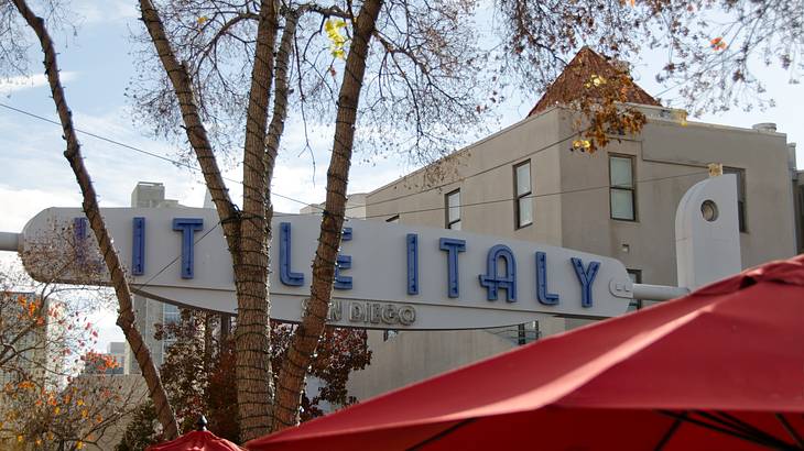 Little Italy signage with buildings in the background and trees nearby